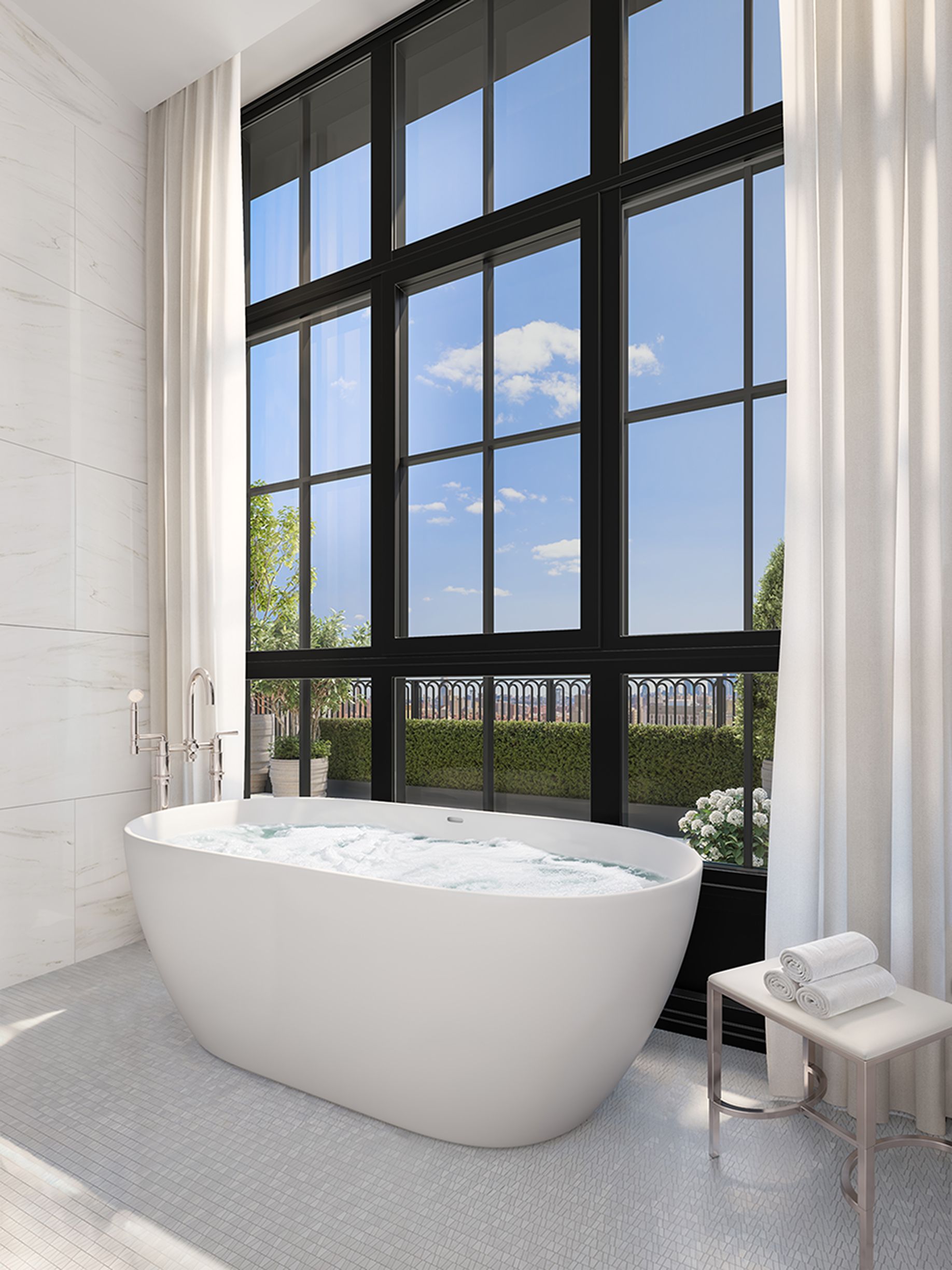 Luxurious bath with huge window and natural light in the penthouse residence at The Willow Gramercy new development.
