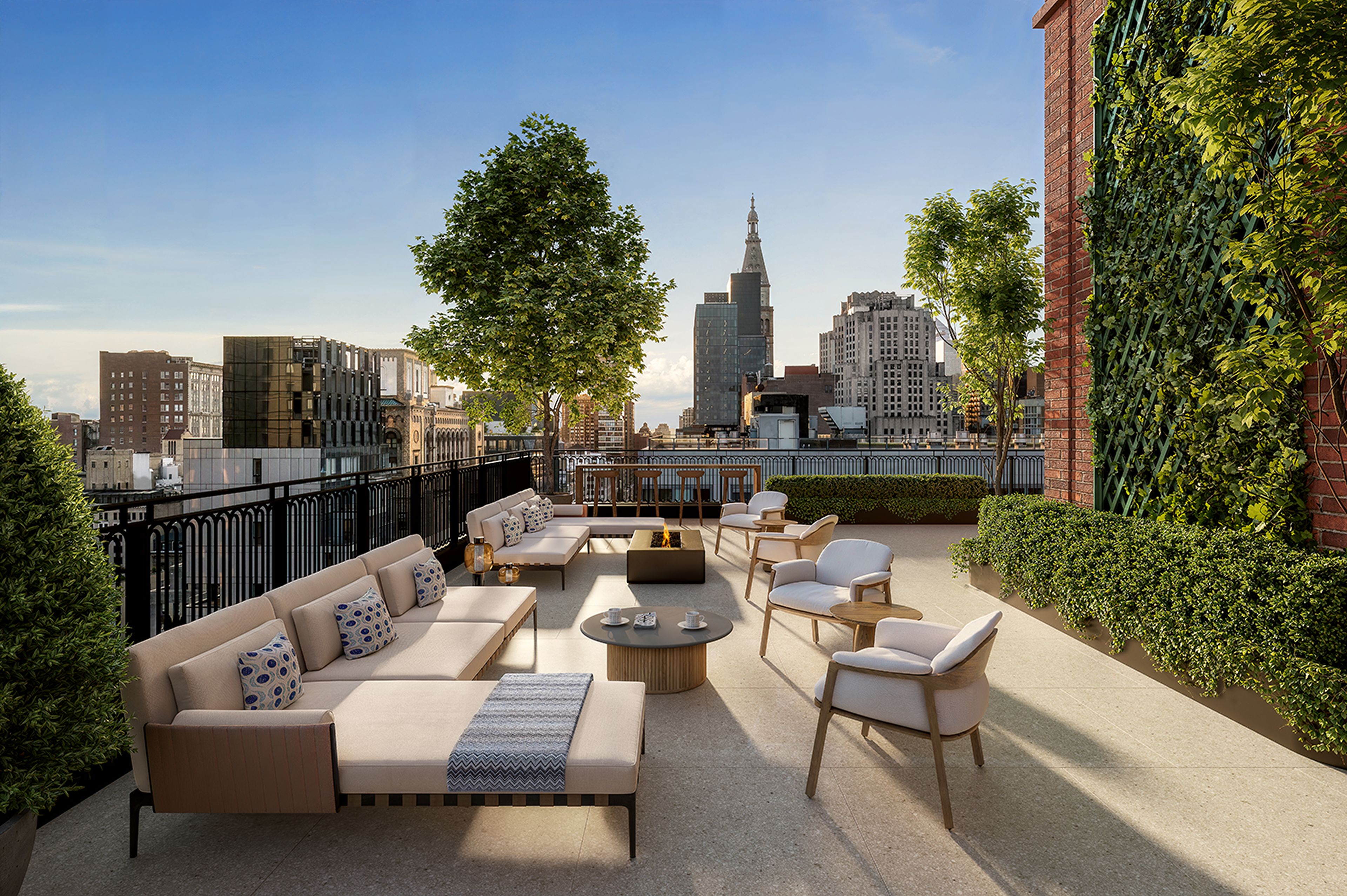 Rooftop terrace with dining & lounging areas overlooking NYC skyline views at The Willow Residences near Gramercy Park.